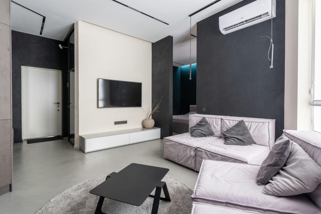 Spacious and stylish modern living room with sleek furnishings and minimalistic decor.
